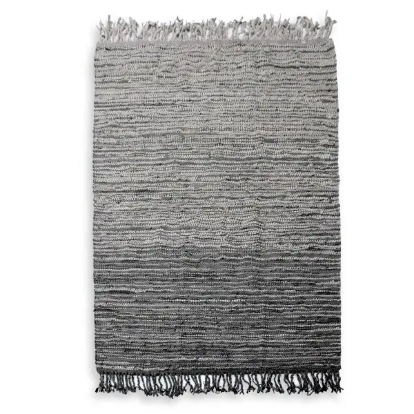 Hand-woven from rescued leather in a taupe-to-charcoal ombre, this rug brings organic texture and rustic character to living spaces and offices.