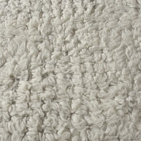 A soft, tufted New Zealand wool shag rug in ivory with a subtle block cutout pattern—an easy, versatile layer for contemporary living spaces.
