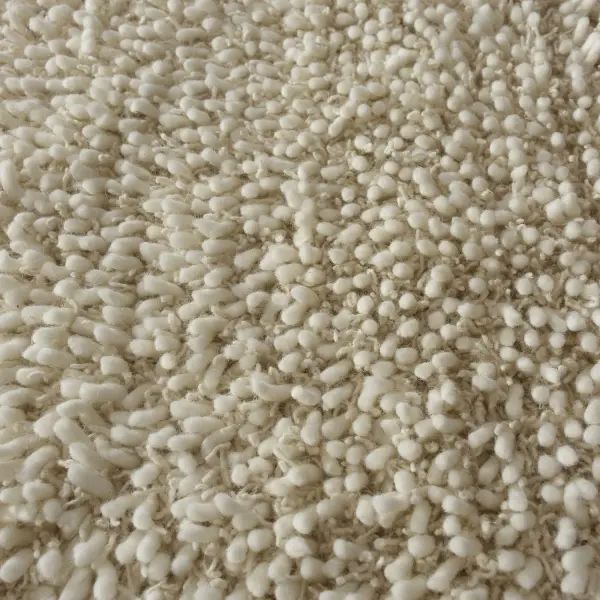 A hand-woven wool shag rug blending dyed and undyed fibers for a soft, textured ivory finish that suits relaxed, organic interiors.