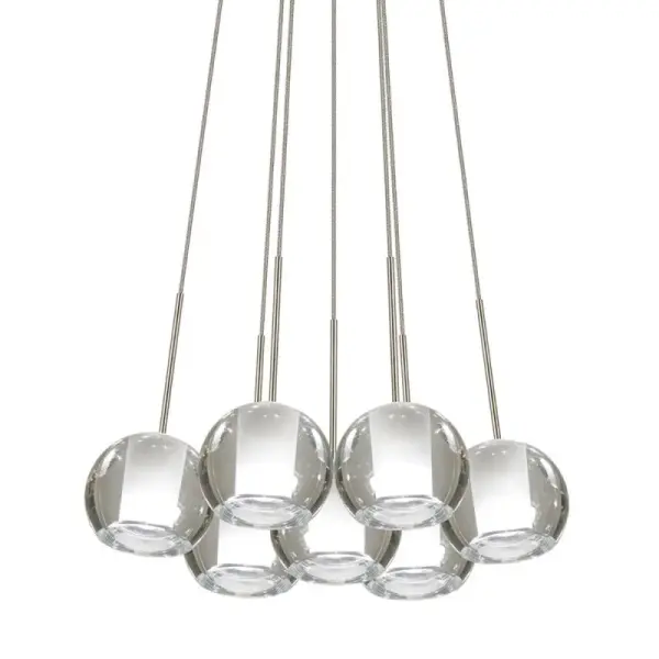 The Gracie Cluster offers flexible cable-mounted lighting with multiple glass globes, available in clear or frosted options. Its adjustable cable system allows for custom height arrangements, making it adaptable to various ceiling heights and room configurations.