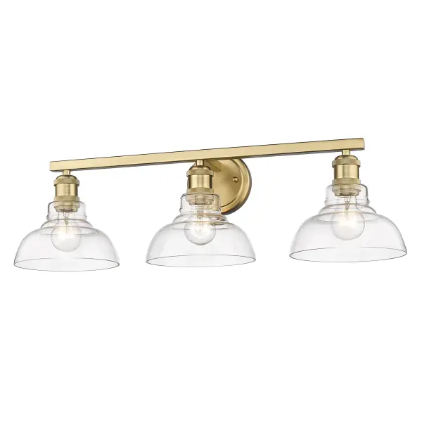 The Carver 3-Light Vanity combines contemporary elegance with industrial charm through its brushed champagne brass finish and clear glass shades. Perfect for modern bathrooms, this damp-rated fixture provides brilliant illumination while showcasing exposed bulbs for added visual interest.