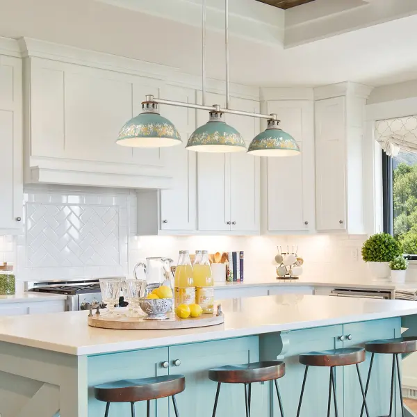 The Kinsley 3-Light Island Light combines farmhouse warmth with industrial edge through its distinctive distressed Antique Teal shades and Aged Galvanized Steel frame. The heavily textured finish reveals layers of gold leaf and off-white, creating visual depth that beautifully reflects light across kitchen islands and dining spaces. - alternate view