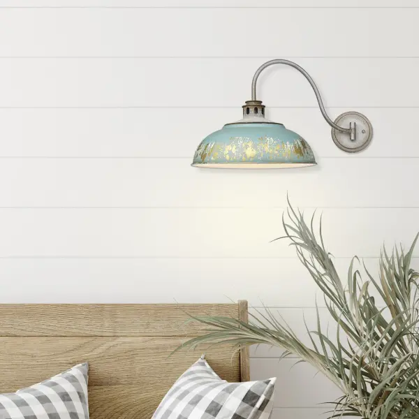 The Kinsley swing arm sconce combines rustic farmhouse elegance with practical adjustability. Its hand-painted Antique Teal shade features multi-layered distressing with chalky white and rustic gold accents, creating authentic vintage character perfect for reading nooks and task lighting. - alternate view