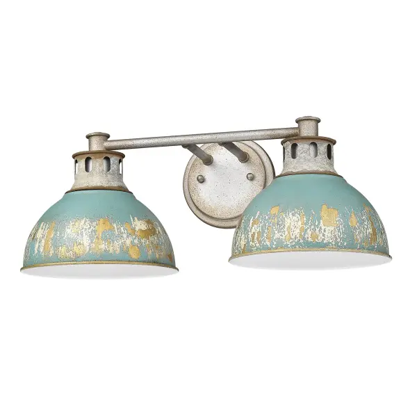 The Kinsley 2-light vanity brings authentic farmhouse character with its distressed antique teal metal shades and aged galvanized steel frame. The weathered finish reveals warm gold leaf underneath, creating inviting ambient light perfect for bathrooms.