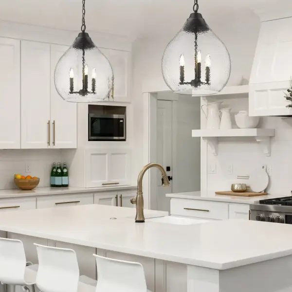 The Ariella 3-Light Pendant combines transitional design with modern farmhouse appeal. Its hammered clear glass shades and matte black finish create stunning light refraction while maintaining a clean, graphic aesthetic that works across multiple decor styles. - alternate view