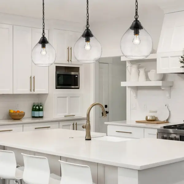 The Ariella pendant combines artisanal hammered glass with a sophisticated matte black frame, creating sparkling refractive light patterns. Its adjustable height and damp location rating make it ideal for kitchens, dining areas, and covered outdoor spaces. - alternate view