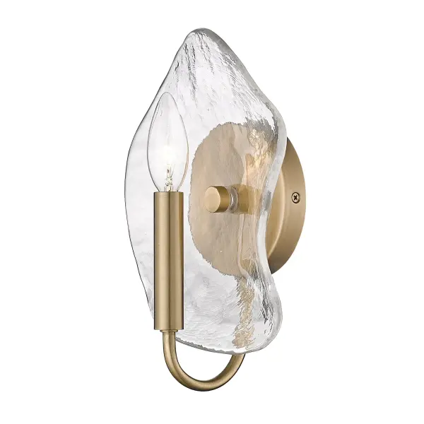 The Samara wall sconce combines warm modern brass with captivating hammered water glass that refracts light into intricate patterns. Damp-rated for bathrooms and hallways, this compact fixture brings nature-inspired artistry to any space.