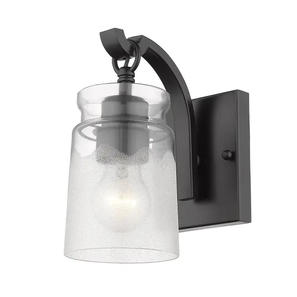 The Travers vanity light combines artisan craftsmanship with versatile design. Its dual-textured glass shade creates captivating light play while the matte black finish complements any decor from industrial to contemporary.