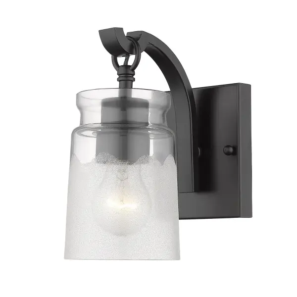 The Travers vanity light combines artisan craftsmanship with versatile design. Its dual-textured glass shade creates captivating light play while the matte black finish complements any decor from industrial to contemporary. - alternate view