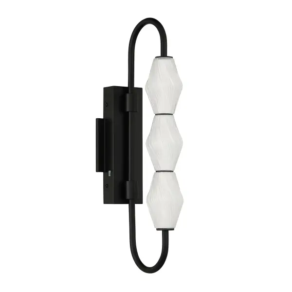 The Golden Lighting Geode 21.5" Integrated LED Outdoor Wall Light brings modern elegance and sculptural interest to exterior spaces with its vertically stacked fluted striped glass shades and clean architectural form. Finished in Matte Black, the steel frame offers a deep, non-reflective surface that enhances the fixture's sleek silhouette while providing timeless contrast against a variety of exterior finishes. The elongated fluted glass diffuses light softly, creating a welcoming glow that enhances safety and curb appeal. Measuring 8.39"W x 21.5"H x 4.72"D, this outdoor wall fixture is perfectly scaled for entryways, patios, and garage doors. Wet-location rated for direct exposure to rain and weather, it features integrated, energy-efficient LED technology delivering 864 lumens of illumination. The built-in 3CCT selector allows you to choose between 3000K, 4000K, or 5000K color temperatures, offering customizable light output to suit any outdoor setting. Collection: Geode Finish: Matte Black Glass: Fluted Striped Glass Width: 4.75" Height: 21.50" Weight: 3.96 lb Extension from Wall: 8.38" Canopy: 10.25"W x 1.63"H x 4.75"D Bulbs Included Number of Bulbs: 3 Maximum Wattage: 13.00 W Bulb Type: Panel Light Source: LED Dimmable Voltage: 120.00 V Country of Origin: China Safety Listing: ETL LED Manufacturer Warranty: 5 Year Limited - alternate view