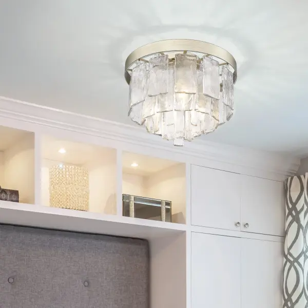 The Ciara flush mount combines sophisticated style with practical functionality. Its hammered water glass shade creates a beautiful light-distorting effect, while the distinctive White Gold finish adds warmth to modern and transitional spaces. - alternate view