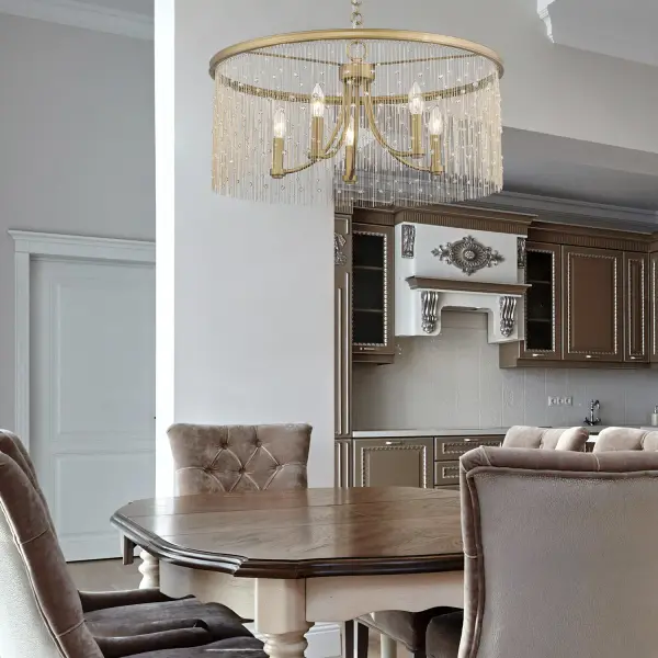 The Marilyn chandelier captivates with its shimmering beaded chain fringe and hand-brushed Peruvian Gold finish. This convertible fixture offers installation flexibility as either a semi-flush mount or pendant, making it perfect for spaces with varying ceiling heights. - alternate view