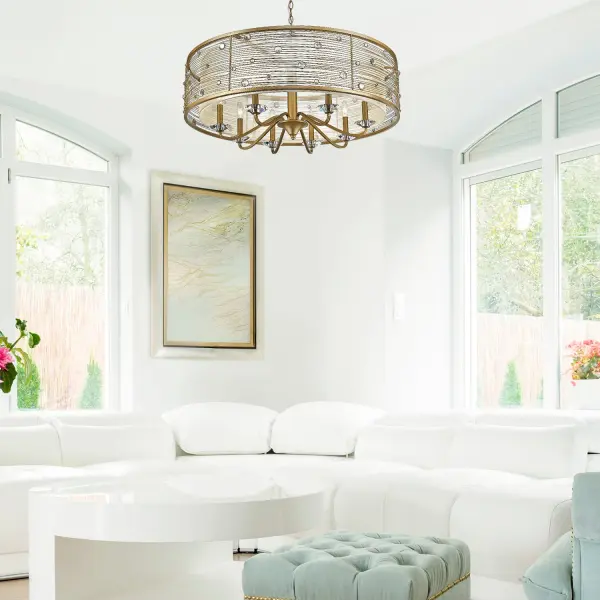The Joia 8-light chandelier combines sophisticated glamour with warm functionality. Its sheer filigree fabric shade diffuses light beautifully while the hand-brushed Peruvian Gold finish adds rustic elegance and timeless charm to any interior space. - alternate view
