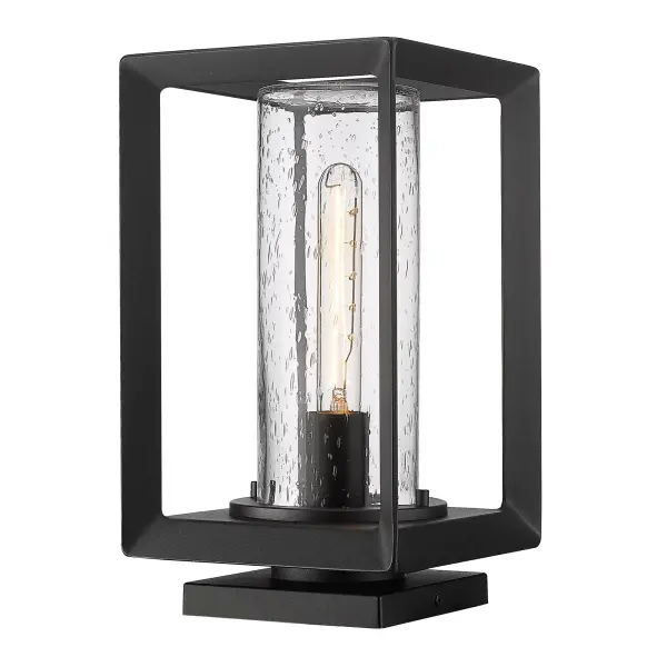 Elevate your outdoor spaces with the timeless elegance of the Golden Lighting Smyth 1-light Outdoor Pier Mount. Featuring a glass shade and a Natural Black frame, it creates a welcoming atmosphere ideal for illuminating pathways and entryways. The seeded glass shade adds a touch of vintage charm with its clear, textured design, characterized by small, infused air bubbles that create a unique, antique-inspired look. When illuminated, the 'seeds' catch the light, gently diffusing the bulb's glow for a warm and inviting ambiance. Crafted with a Natural Black finish, this fixture presents a softer, organic take on the classic black look, with a chalky, non-reflective matte surface that complements a wide range of styles from modern farmhouse to industrial. Flexibly designed for versatile mounting options, it can be installed on a pier or a post, making it perfect for various outdoor settings. Plus, it's Wet Location Rated, ensuring it withstands the elements, whether rain or shine. Overall Dimensions: 7.5"W x 13.25"H x 7.5"D. Requires 1 E26 Medium base bulb (not included) with a maximum wattage of 100. This high-quality outdoor pier mount light not only adds functional illumination but also enhances the aesthetic of your outdoor spaces, making it a perfect choice for any home.