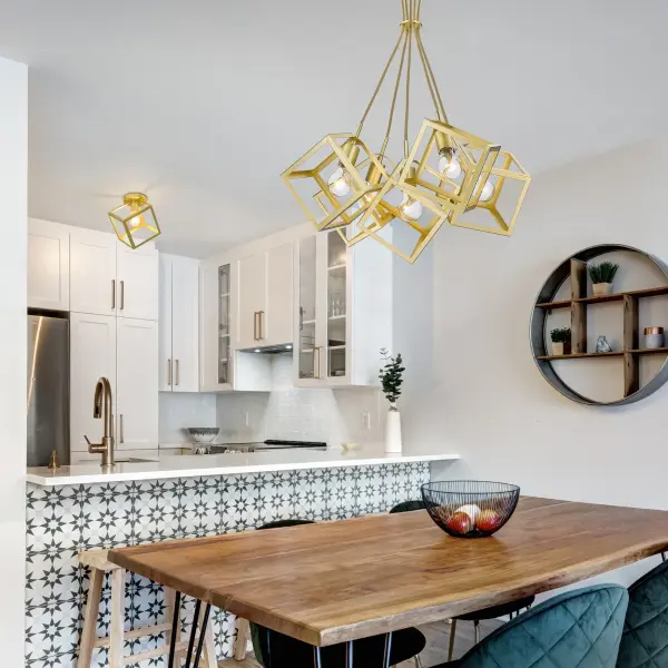 The Cassio 5-Light Chandelier combines industrial open-frame design with sophisticated Olympic Gold finish. Its exposed bulb design creates inviting ambient light while the matte gold surface adds contemporary warmth without excessive shine. - alternate view