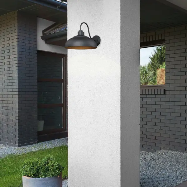 The Levitt outdoor wall sconce combines farmhouse elegance with industrial strength. Its Natural Black finish offers an organic, raw iron aesthetic that complements modern farmhouse and transitional designs while standing up to harsh weather. - alternate view