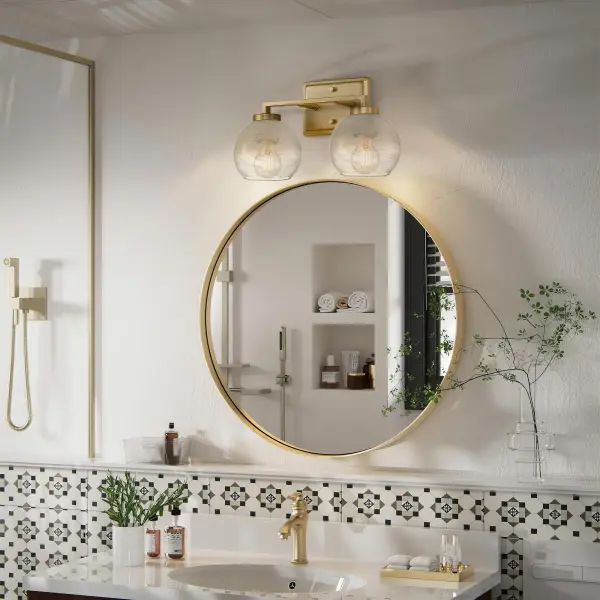 The Elliott 2-Light Vanity combines glamorous style with practical functionality. Its brushed champagne brass finish offers a refined alternative to traditional gold, while clear alabaster glass shades with swirled patterns create a soft, diffused glow perfect for bathroom tasks and ambiance. - alternate view
