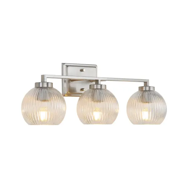 The Elliott 3-Light Vanity combines vintage charm with modern sophistication. Its clear ribbed glass shades beautifully refract light while the pewter finish adds a soft, classic touch. Damp-rated for bathroom use.