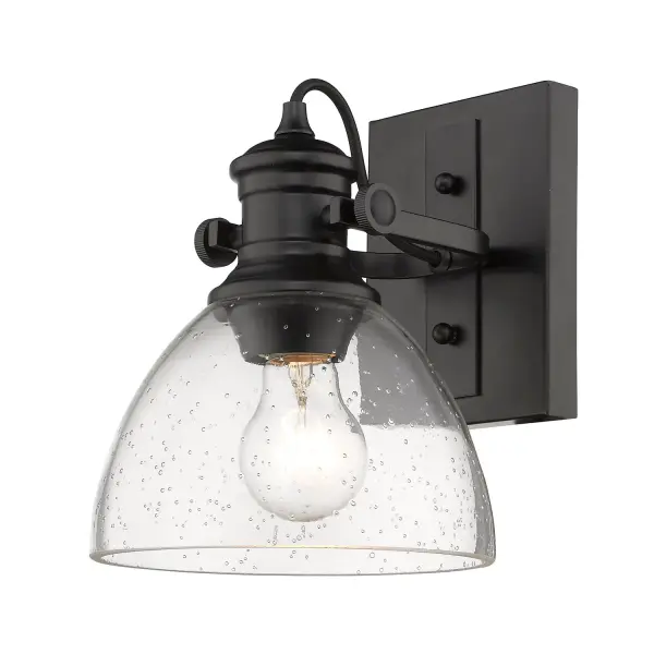 The Hines semi-flush mount combines farmhouse character with industrial edge through its seeded glass shade and matte black finish. Perfect for mid-height ceilings, this compact fixture offers adjustable directional lighting. - alternate view
