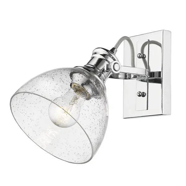 The Hines vanity light combines farmhouse elegance with practical functionality. Its seeded glass shade creates warm, inviting ambiance while the polished chrome finish adds timeless sophistication to any bathroom.