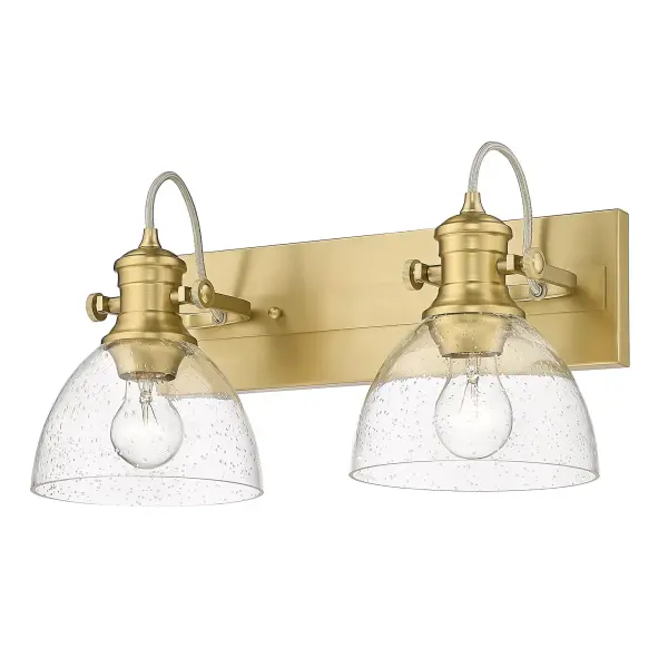 The Hines 2-Light Vanity combines artisanal seeded glass with sophisticated Brushed Champagne Brass for a warm, vintage-inspired look. Adjustable directional heads offer practical flexibility while the damp-rated design ensures durability.