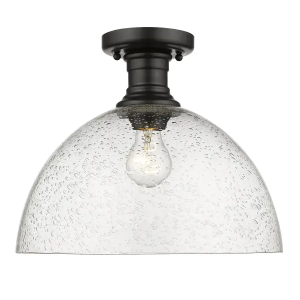 The Hines semi-flush mount combines contemporary sophistication with farmhouse charm through its seeded glass shade and matte black finish. Perfect for mid-height ceilings, it delivers warm ambient lighting with vintage character.