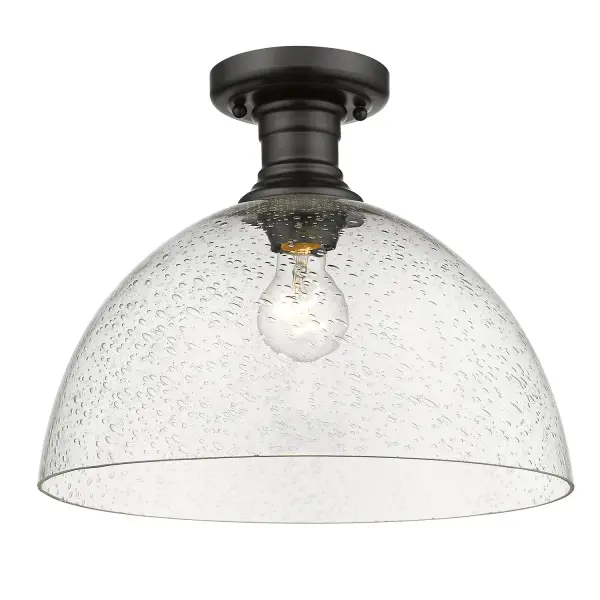 The Hines semi-flush mount combines contemporary sophistication with farmhouse charm through its seeded glass shade and matte black finish. Perfect for mid-height ceilings, it delivers warm ambient lighting with vintage character. - alternate view