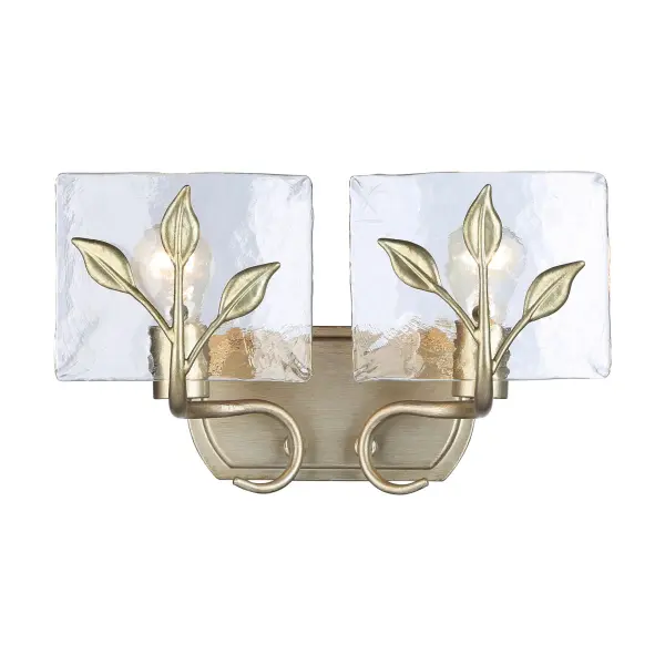 The Calla 2-Light Vanity combines artisanal craftsmanship with functional design. Its hammered water glass creates a beautifully refractive light effect, while the brushed White Gold finish adds warmth and sophistication to any bathroom space.
