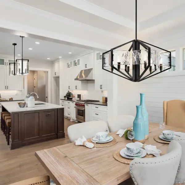The Varsha 6-Light Chandelier combines modern elegance with industrial edge through its matte black frame and distinctive hammered water glass shades. The textured glass creates captivating light patterns while the versatile black finish complements multiple design styles. - alternate view