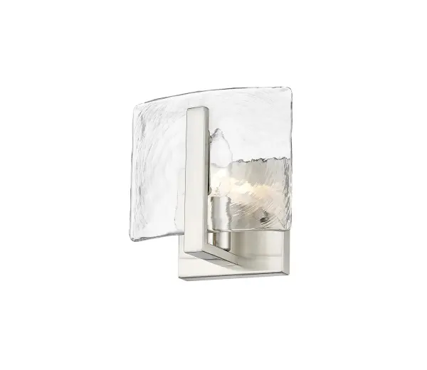 The Aenon wall sconce combines artisan craftsmanship with practical illumination. Its hammered water glass shade creates a stunning flowing water effect, while the pewter finish adds understated warmth suitable for both traditional and contemporary spaces.