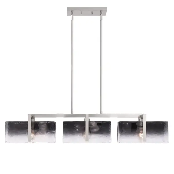 Aenon 3-light Island Light delivers understated elegance with organic texture. Finished in brushed Pewter, the streamlined frame showcases thick Smokey Water Glass panels inspired by natural water movement and ice. The smoky gray glass softens illumination while the hammered texture creates depth and visual intrigue. Measuring 40.5"W x 8.13"H x 8.88"D, this fixture is ideally scaled for kitchen islands and elongated spaces. Adjustable height and sloped-ceiling compatibility ensure versatile installation with lasting style. - alternate view