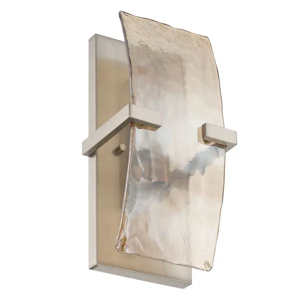 Aenon 2-light Wall Sconce blends timeless metalwork with nature-inspired glass. Finished in softly brushed Pewter, the fixture’s vertical frame highlights thick Amber Water Glass panels that evoke flowing water and molten ice. The warm amber tone enriches the light output, while the deeply hammered texture refracts illumination into dynamic patterns. Measuring 6.25"W x 13"H x 4.75"D, this sconce is perfectly proportioned for bathrooms, hallways, stairways, and cozy living spaces. Damp-location rated, it delivers functional lighting with elevated visual appeal. - alternate view