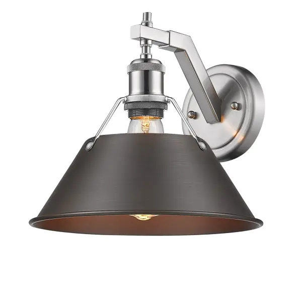 The Orwell Wall Sconce combines pewter and rubbed bronze finishes with a textured metal shade for warm, diffused lighting. Damp-rated and compact at 10"W, it's perfect for hallways, bathrooms, and bedrooms.
