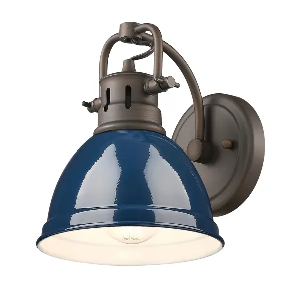 The Duncan vanity light combines rustic farmhouse charm with a sophisticated navy blue metal shade. Its adjustable directional head and damp location rating make it both practical and versatile for bathrooms and laundry rooms.