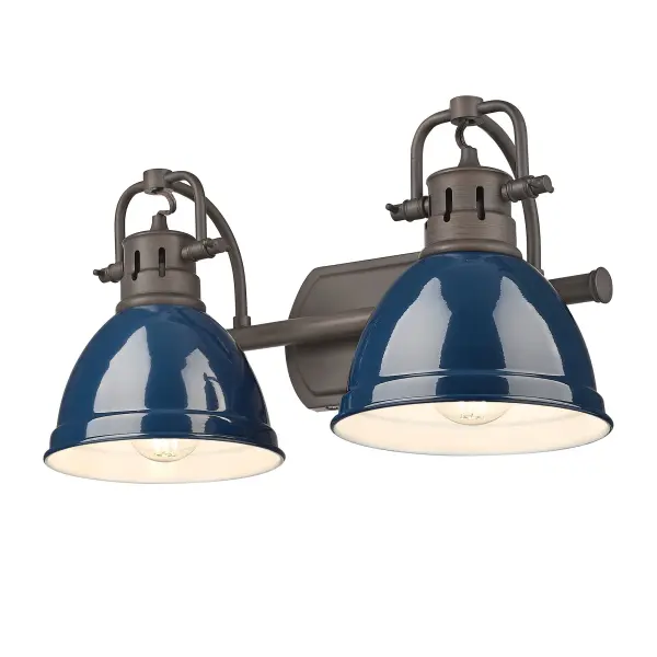 The Duncan 2-Light Vanity combines traditional farmhouse charm with sophisticated nautical style. Featuring adjustable directional heads and a striking navy blue shade paired with warm rubbed bronze, it delivers both practical task lighting and bold design appeal for bathrooms.