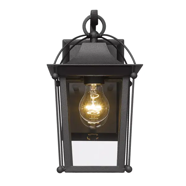 The Brigham outdoor wall sconce combines traditional elegance with practical durability. Its natural black finish and clear glass shade create a welcoming glow at entryways and patios, while wet location rating ensures year-round performance. - alternate view