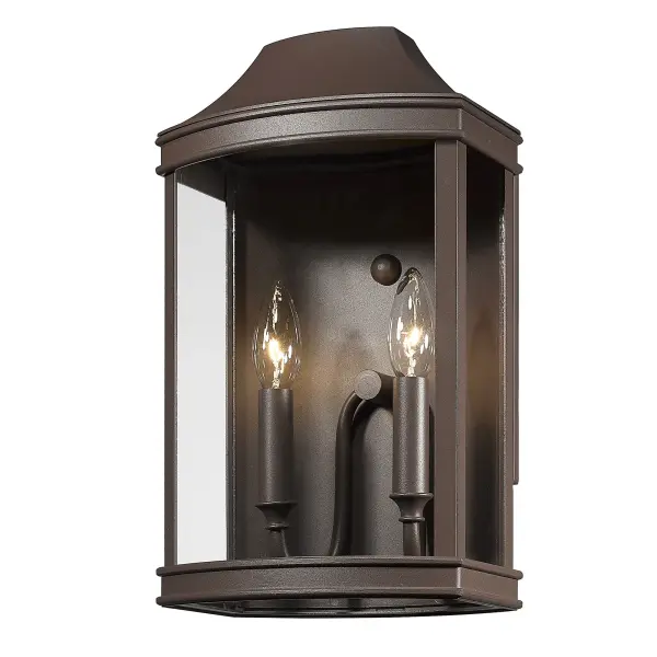 The Cohen outdoor wall sconce combines traditional elegance with rugged durability. Its textured bronze finish and clear glass design create inviting illumination for entryways, patios, and garage areas.