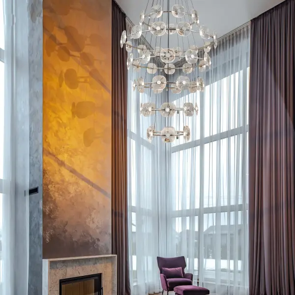 The Celestia 59-light chandelier is a show-stopping statement piece featuring K9 crystal discs that create a mesmerizing halo effect. With 57" width and adjustable height up to 209.75", it delivers 3088 lumens of warm LED light perfect for grand spaces. - alternate view