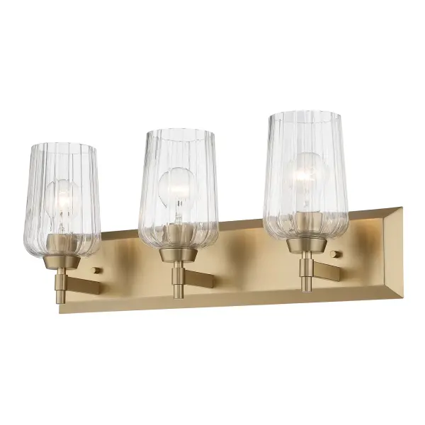 The Yep by Golden Lighting Brilia 3-Light Vanity offers a sophisticated balance of classic form and modern detailing. A clean rectangular backplate and streamlined metal arms provide a structured foundation, while clear fluted glass shades introduce subtle texture and architectural interest. The vertical ribbing gently refracts light, creating a bright, even glow with crisp clarity and visual depth. Finished in Brushed Champagne Brass, the electroplated frame features a soft satin luster with warm, muted gold tones that add understated elegance without overpowering the design. Measuring 24"W x 8.63"H x 6.63"D, this vanity fixture is ideal for bathrooms, powder rooms, and dressing areas where functional task lighting and refined style are equally important. Damp-location rated, it is well suited for covered and moisture-prone spaces and requires three E26 medium-base bulbs (not included). Collection: Brilia Finish: Brushed Champagne Brass Glass: Fluted Glass Width: 24.00" Height: 9.25" Extension from Wall: 6.13" Canopy: 24"W x 4.87"H x 0.75"D Number of Bulbs: 3 Maximum Wattage: 60.00 W Bulb Type: A19 Bulb Base: E26 Dimmable Voltage: 120.00 V Country of Origin: China Safety Listing: ETL Manufacturer Warranty: 1 Year Limited