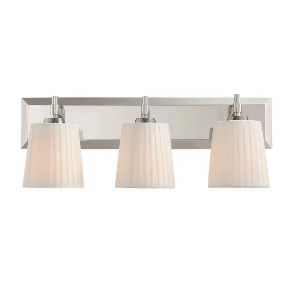 The Golden Lighting Brilia 3-Light Vanity offers a sophisticated blend of structure and softness through its clean-lined metal framework and tailored shade design. Three pleated linen shades are supported by streamlined arms extending from a rectangular backplate, creating a balanced silhouette that feels both classic and contemporary. The finely woven fabric gently diffuses light, producing a warm, even glow while minimizing glare. Finished in Polished Nickel, the electroplated metal features a bright, mirror-like sheen with subtle warmth that adds polished refinement. Measuring 24"W x 9.25"H x 6.13"D, this vanity is ideal for bathrooms and powder rooms. Damp-location rated for added flexibility, it requires three E26 medium base bulbs (not included), each up to 60 watts. - alternate view