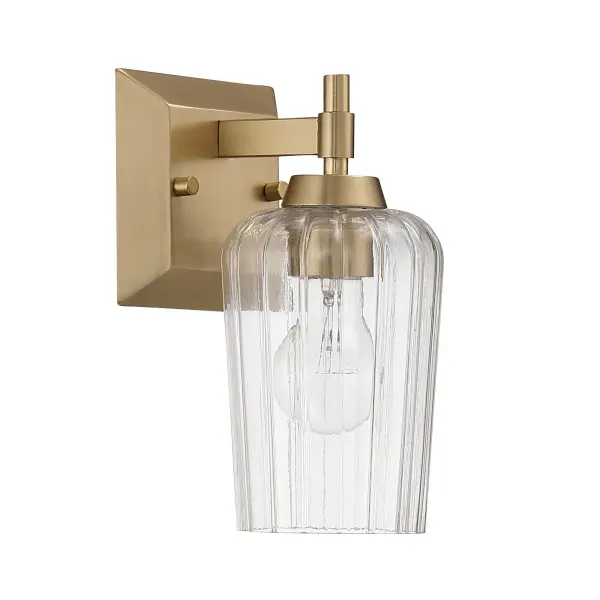 The Yep by Golden Lighting Brilia 1-Light Wall Sconce delivers a refined balance of classic form and modern detailing. Clean metal lines and a compact rectangular backplate create a tailored silhouette, while the clear fluted glass shade introduces subtle texture and architectural interest. Finished in Brushed Champagne Brass, the electroplated surface features a soft satin sheen with warm undertones that elevate both modern and transitional interiors. The vertically ribbed glass softly refracts light for bright, even illumination with crisp clarity. Measuring 4.88"W x 9.25"H x 6.13"D, this sconce is ideal for hallways, bathrooms, stairways, bedrooms, and entryways. Damp-location rated for covered spaces, it uses one E26 medium-base bulb (not included) for flexible lighting options. Collection: Brilia Finish: Brushed Champagne Brass Glass: Fluted Glass Width: 4.88" Height: 9.25" Weight: 2.20 lb Extension from Wall: 6.13" Canopy: 24"W x 4.87"H x 0.75"D Number of Bulbs: 1 Maximum Wattage: 60.00 W Bulb Type: A19 Bulb Base: E26 Dimmable Voltage: 120.00 V Country of Origin: China Safety Listing: ETL Manufacturer Warranty: 1 Year Limited - alternate view