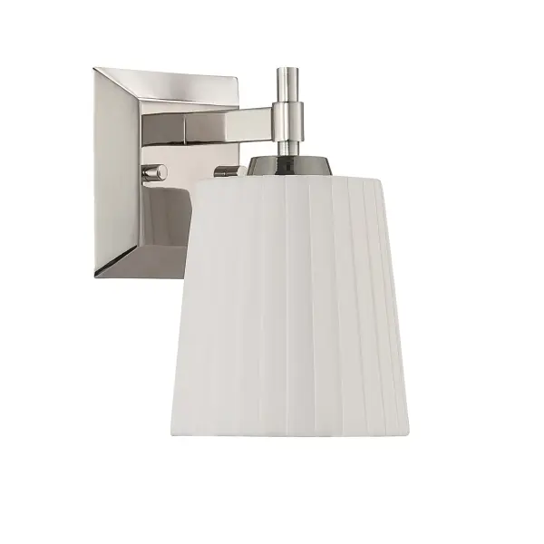The Golden Lighting Brilia 1-Light Wall Sconce delivers understated elegance through refined materials and clean-lined construction. Finished in Polished Nickel, the metal framework provides a bright, reflective surface that complements both traditional and contemporary interiors. The pleated linen shade introduces tailored texture and gently diffuses light, creating a warm, inviting glow with subtle shadowing. Perfect for bathrooms, bedrooms, hallways, and living areas, this wall sconce balances decorative detail with functional lighting. Damp-location rated and compatible with one E26 medium-base bulb (not included), it offers flexible illumination options. Measuring 4.88"W x 9.25"H x 6.13"D, the Brilia wall sconce adds timeless sophistication and soft ambient light to any space. - alternate view