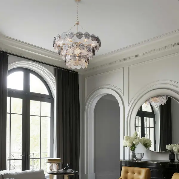 The Cascada 13-light pendant combines coastal elegance with contemporary sophistication through hammered water glass discs and an artisanal Aegean Silver finish. Its generous 31.75" diameter creates dramatic visual impact while the smoke plated glass offers dynamic lighting effects. - alternate view