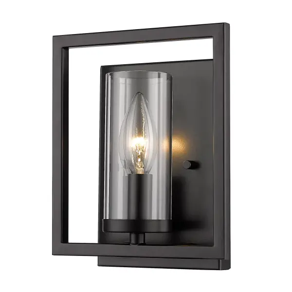 The Marco wall sconce combines minimalist design with sophisticated style. Its clear glass shade showcases the bulb while the matte black finish adds depth without reflection. Perfect for creating ambient lighting in compact spaces.