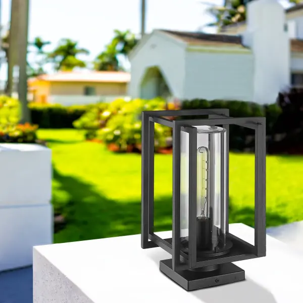The Golden Lighting Tribeca outdoor pier mount combines classic elegance with modern durability. Its natural black finish and clear glass shade create a sophisticated look that complements various architectural styles while providing reliable illumination for pathways and entryways. - alternate view