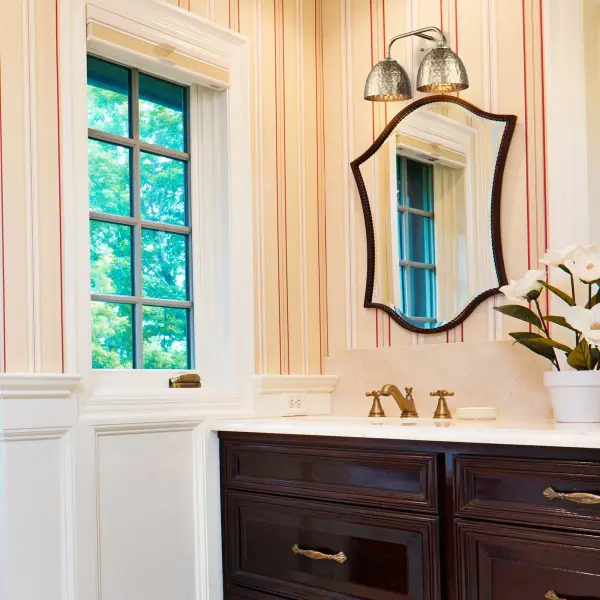 The Shepard 2-Light Vanity combines traditional elegance with farmhouse charm, featuring a sophisticated Modern Brass finish and matching metal shades. Damp-rated for bathroom versatility with practical task lighting. - alternate view