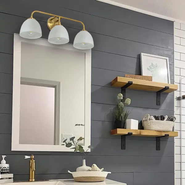 The Shepard 3-Light Vanity combines farmhouse charm with modern sophistication. Its modern brass frame and matte white metal shade create a welcoming atmosphere while providing practical task lighting for bathrooms and powder rooms. - alternate view