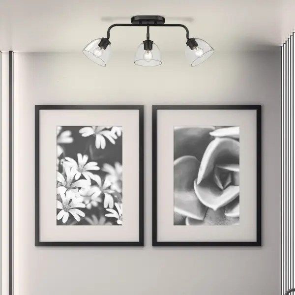 The Roxie 3-light semi-flush mount combines timeless matte black styling with practical adjustable heads, making it ideal for mid-height ceilings. Clear glass shades showcase decorative bulbs while providing brilliant light. - alternate view
