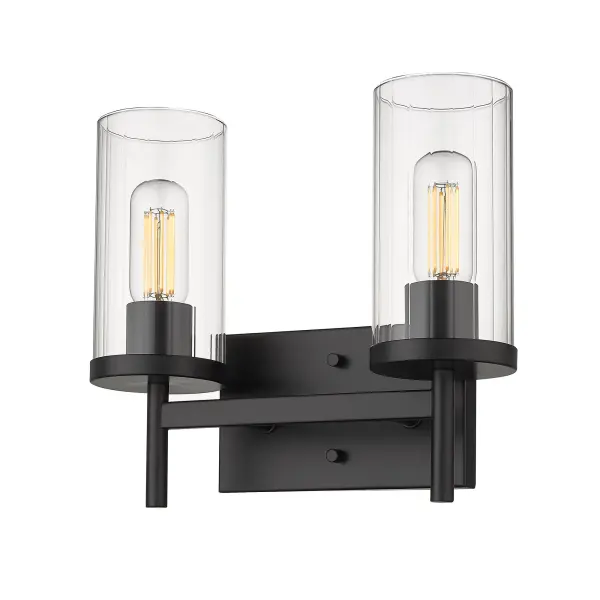 The Winslett 2-Light Vanity combines modern minimalism with transitional elegance. Its matte black finish and clear ribbed glass shades create sophisticated task lighting perfect for bathrooms, delivering both style and practical illumination.