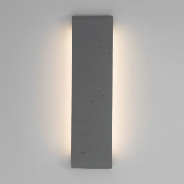 The Golden Lighting Stela 24" Integrated LED Outdoor Wall offers a sophisticated architectural lighting solution inspired by the organic beauty of natural stone. Crafted from concrete, its gently curved form is finished in Gray Travertine, featuring a soft neutral grey tone accented by subtle pitting and mineral variation. Integrated linear LED lighting is seamlessly recessed into the fixture, providing smooth ambient illumination that enhances the sculptural silhouette without distraction. Measuring 23.75"W x 6.25"H x 1.75"D, this fixture is ideal for larger exterior walls, garage facades, patios, and entryways. Wet-location rated for direct exposure to the elements, it delivers 1820 lumens at 3000K, combining durability with refined modern design Collection: Stela Finish: Gray Travertine Width: 23.75" Height: 6.25" Weight: 9.00 lb Extension from Wall: 1.75" Canopy: 22"W x 3"H x 0.5"D Bulbs Included Number of Bulbs: 1 Maximum Wattage: 21.00 W Bulb Type: Panel Light Source: LED Dimmable Voltage: 120.00 V Country of Origin: China Safety Listing: ETL ADA LED Manufacturer Warranty: 5 Year Limited